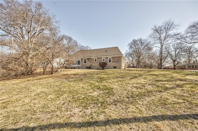 back of property featuring a lawn