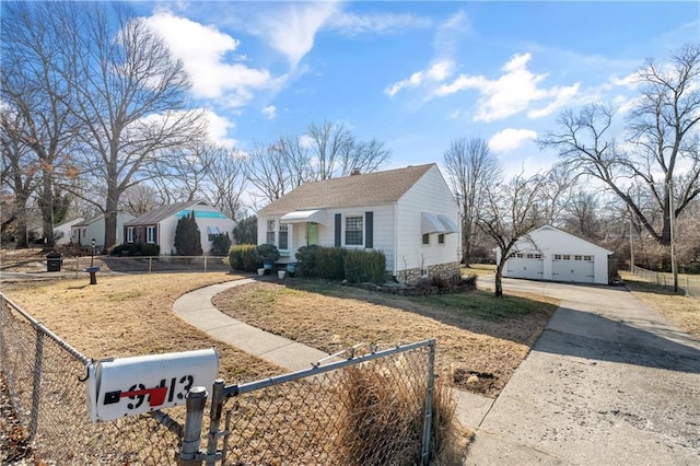 view of front of property featuring a fenced front yard, a chimney, a detached garage, and an outdoor structure