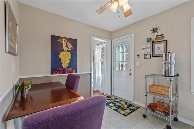 foyer featuring baseboards and a ceiling fan