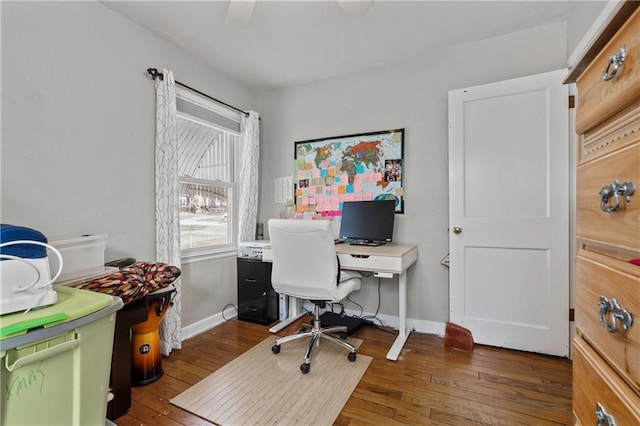 home office featuring baseboards and wood-type flooring