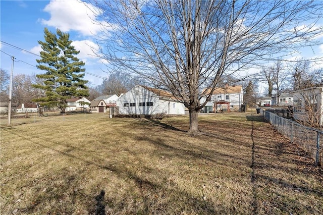 view of yard with a residential view and fence