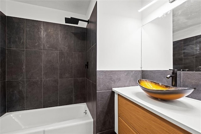 full bath featuring tile walls and vanity