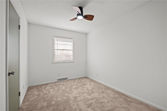 unfurnished bedroom with visible vents, baseboards, ceiling fan, carpet, and a textured ceiling