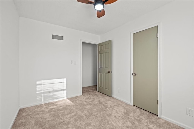 unfurnished bedroom with visible vents, baseboards, carpet, and a ceiling fan