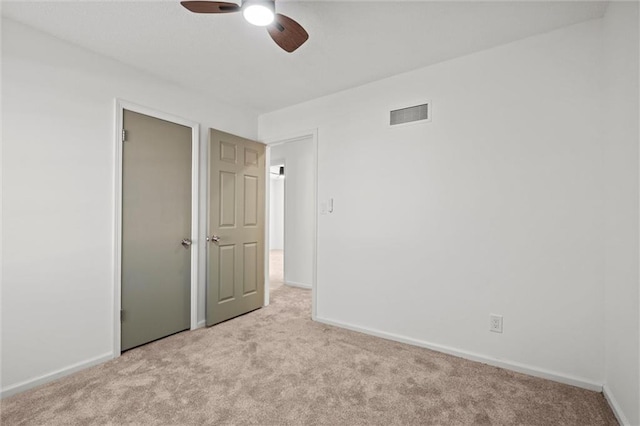 unfurnished bedroom with carpet flooring, baseboards, visible vents, and a closet