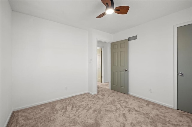 unfurnished bedroom with visible vents, carpet flooring, a ceiling fan, and baseboards