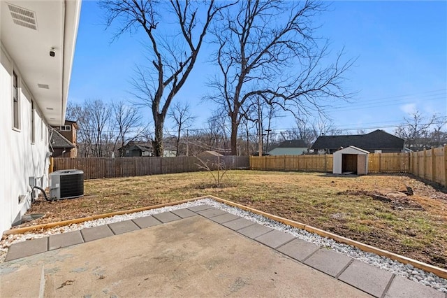 view of patio with an outdoor structure, central AC unit, visible vents, and a fenced backyard