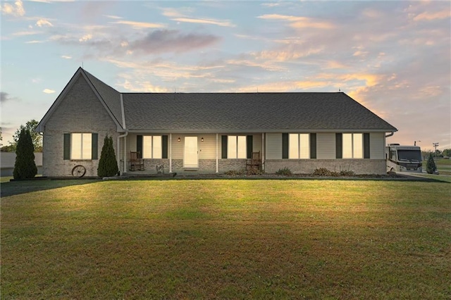 view of front facade featuring brick siding and a front yard