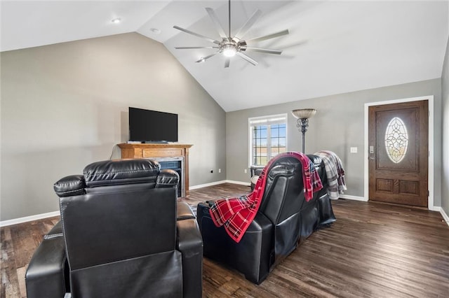 living room featuring dark wood-style floors, a ceiling fan, and vaulted ceiling