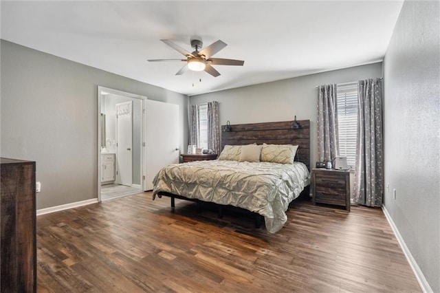 bedroom with a ceiling fan, ensuite bathroom, baseboards, and wood finished floors