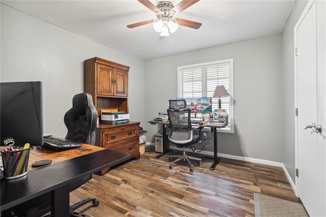 office space featuring baseboards, a ceiling fan, and wood finished floors