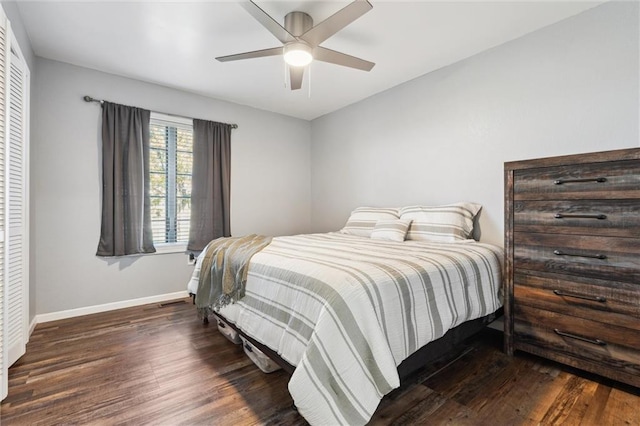 bedroom with a ceiling fan, baseboards, and wood finished floors