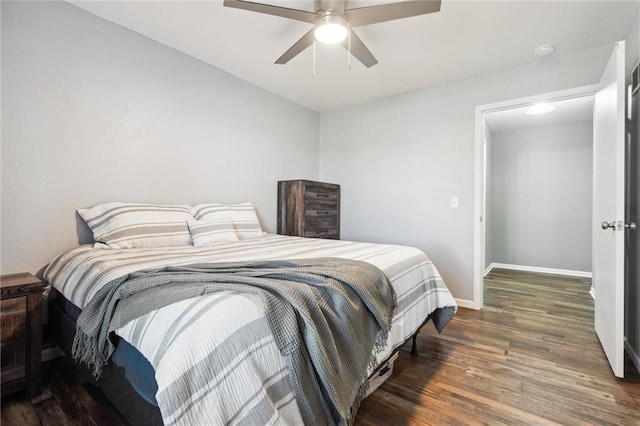 bedroom featuring ceiling fan, baseboards, and wood finished floors