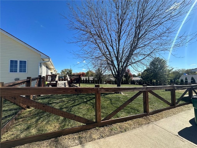 view of yard with a deck and fence