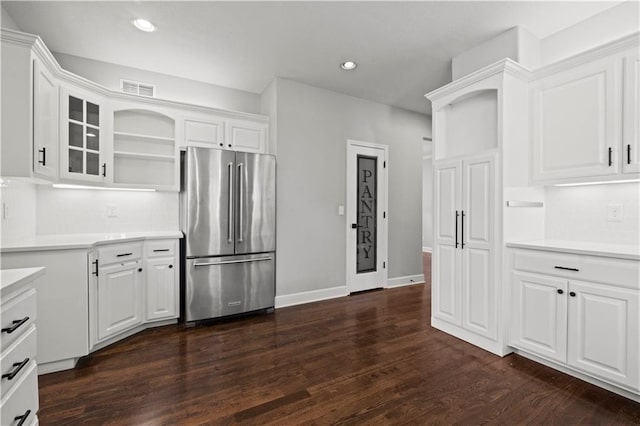 kitchen featuring high end refrigerator, visible vents, light countertops, white cabinetry, and open shelves