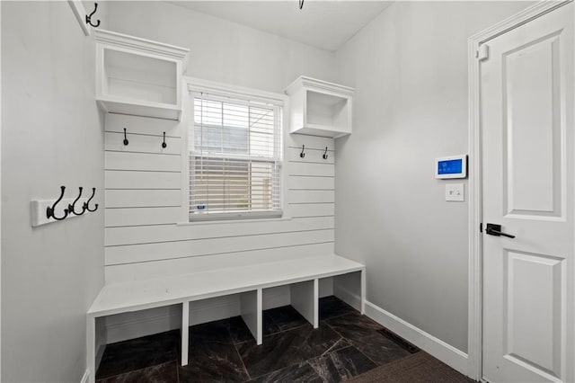 mudroom with marble finish floor and baseboards