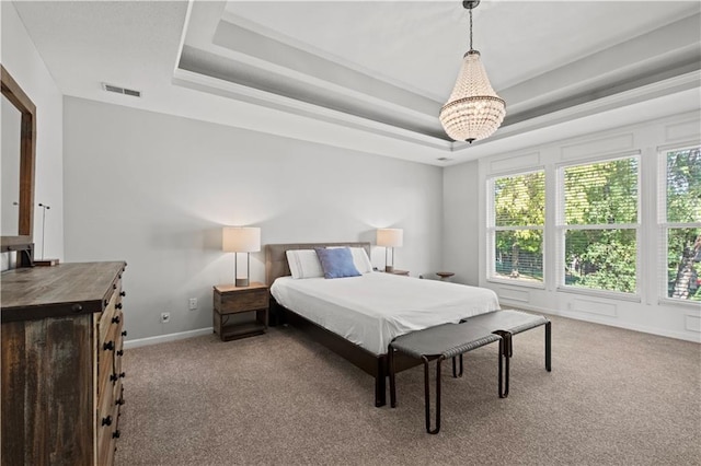 carpeted bedroom with a raised ceiling, visible vents, and baseboards