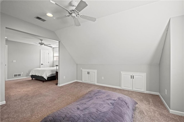 bedroom with carpet floors, lofted ceiling, and visible vents