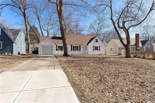 view of front of property with an attached garage, a residential view, and concrete driveway