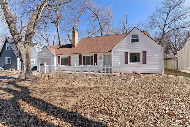 view of front facade featuring a fenced front yard, roof with shingles, and a chimney