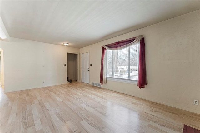 empty room featuring visible vents and light wood finished floors