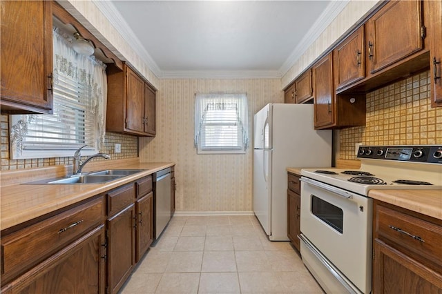 kitchen featuring white appliances, light tile patterned floors, wallpapered walls, light countertops, and a sink