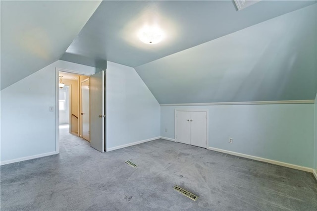 bonus room featuring baseboards, visible vents, and carpet flooring