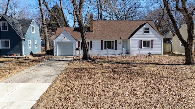 view of front of home with an outdoor structure, driveway, an attached garage, and fence