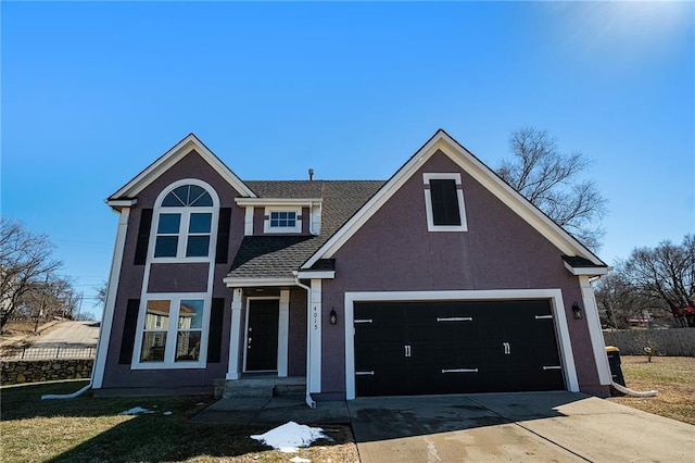 traditional home featuring stucco siding, a shingled roof, concrete driveway, fence, and a garage