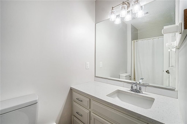 full bathroom with vanity and toilet