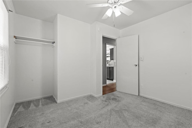 unfurnished bedroom with carpet floors, a closet, ceiling fan, and baseboards