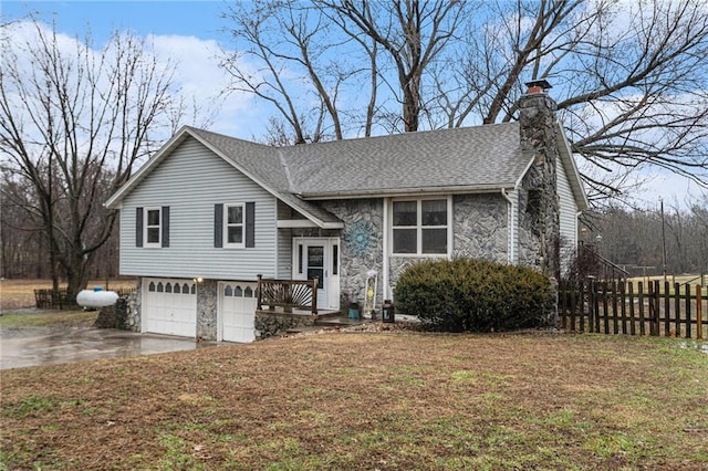 view of front of property with an attached garage, a shingled roof, fence, concrete driveway, and a chimney