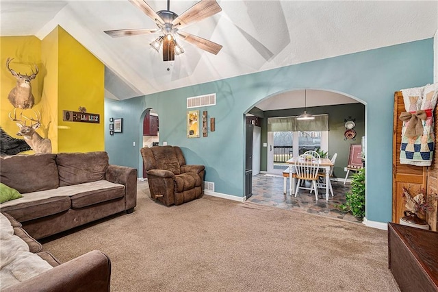 carpeted living area featuring visible vents, arched walkways, baseboards, lofted ceiling, and ceiling fan