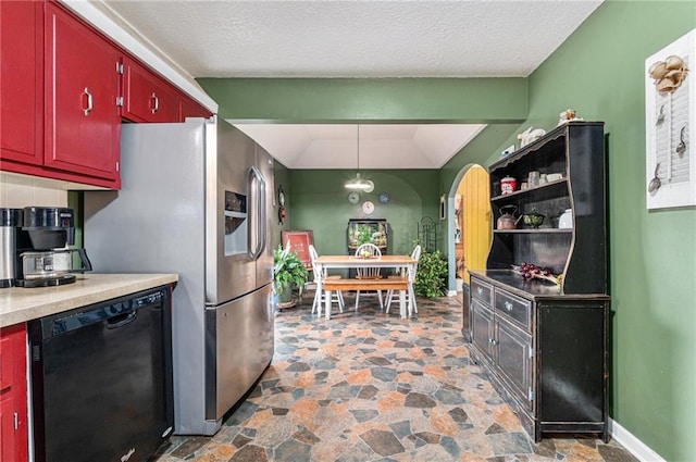 kitchen featuring pendant lighting, black dishwasher, red cabinetry, stone finish floor, and baseboards