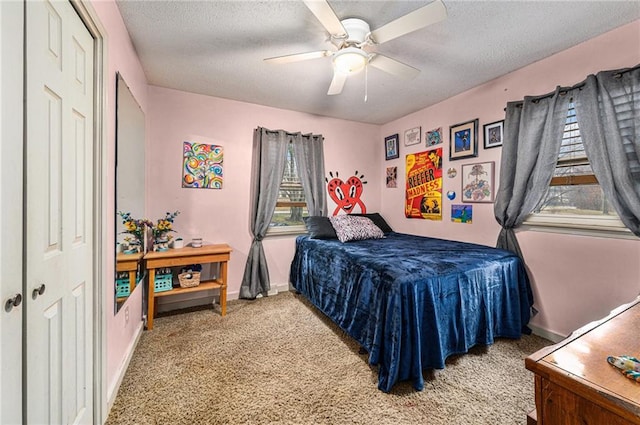 bedroom featuring a textured ceiling, carpet, a ceiling fan, and baseboards