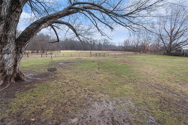 view of yard with a rural view and fence