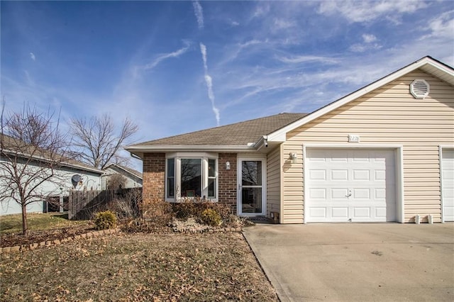 single story home with an attached garage, concrete driveway, and brick siding