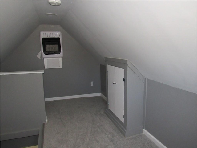 additional living space featuring carpet floors, heating unit, baseboards, and lofted ceiling