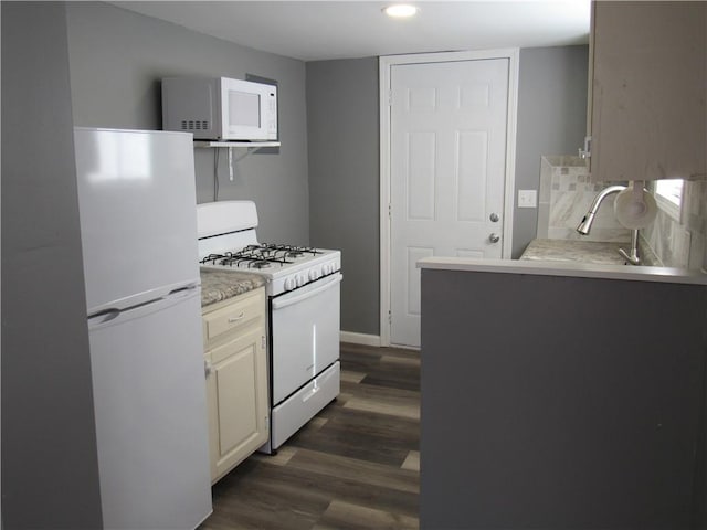 kitchen with dark wood-style floors, white appliances, light countertops, and cream cabinets