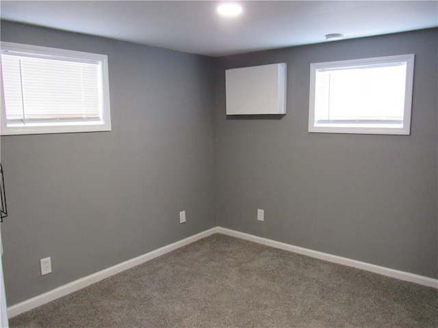 unfurnished room with carpet floors and baseboards