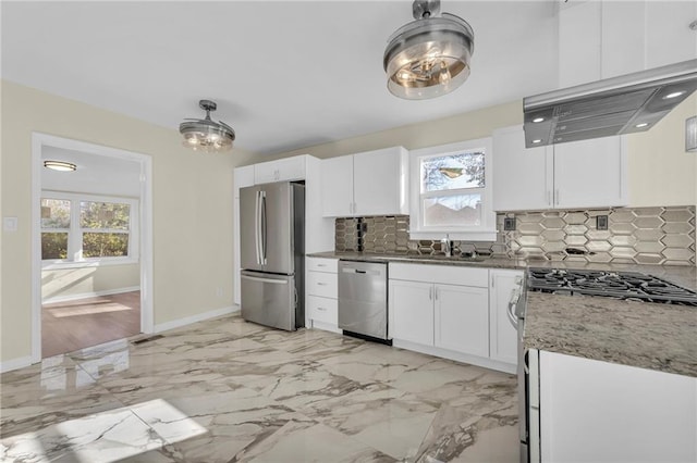 kitchen featuring marble finish floor, appliances with stainless steel finishes, white cabinetry, and light stone countertops