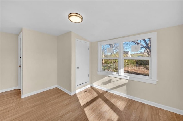 empty room featuring light wood-style floors and baseboards