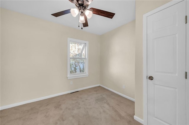 unfurnished room with light carpet, ceiling fan, and baseboards