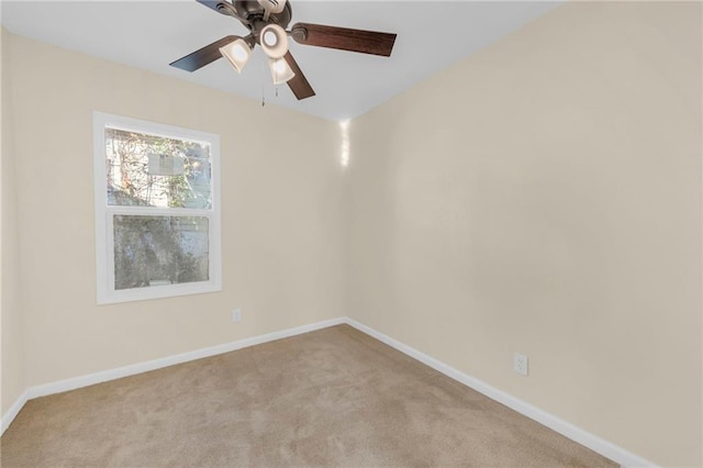 empty room with light carpet, baseboards, and a ceiling fan