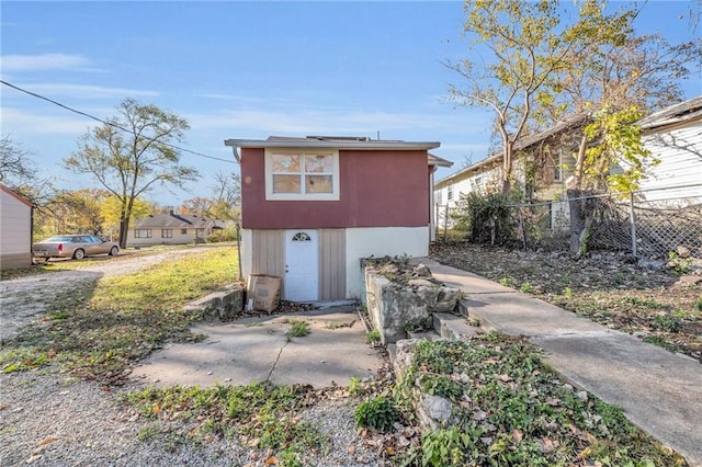 view of outbuilding with fence