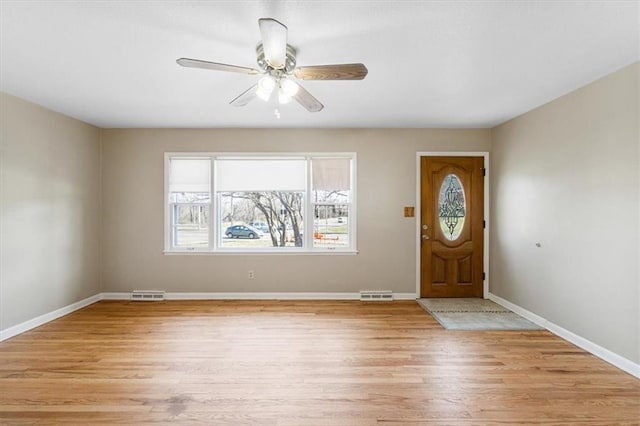 entryway featuring visible vents, baseboards, light wood-style floors, and ceiling fan