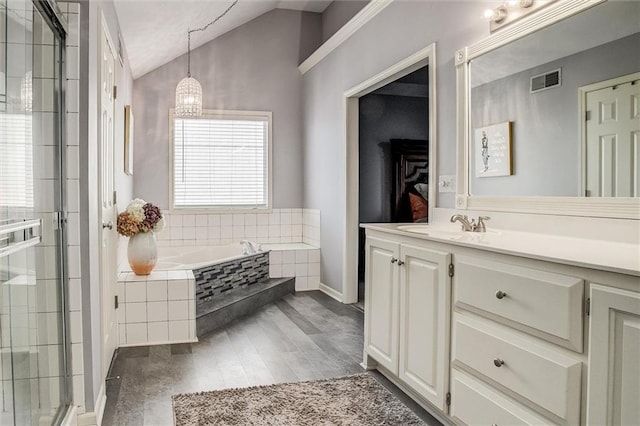 bathroom with vanity, vaulted ceiling, visible vents, and a stall shower