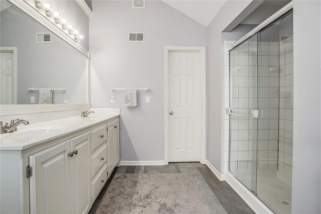 full bathroom with a sink, vaulted ceiling, visible vents, and a stall shower