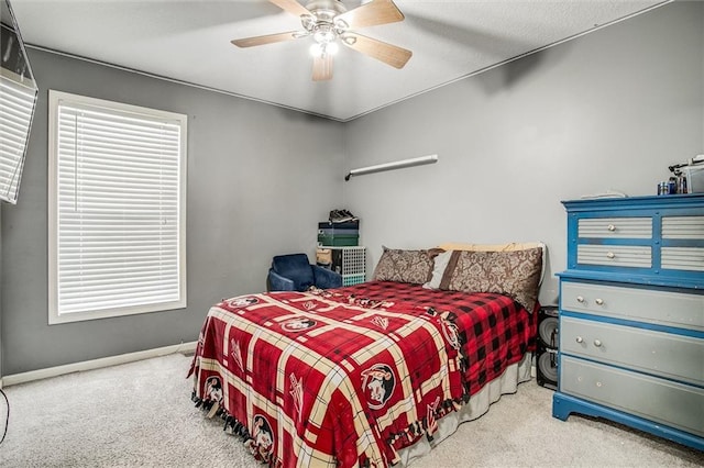 carpeted bedroom with baseboards and ceiling fan