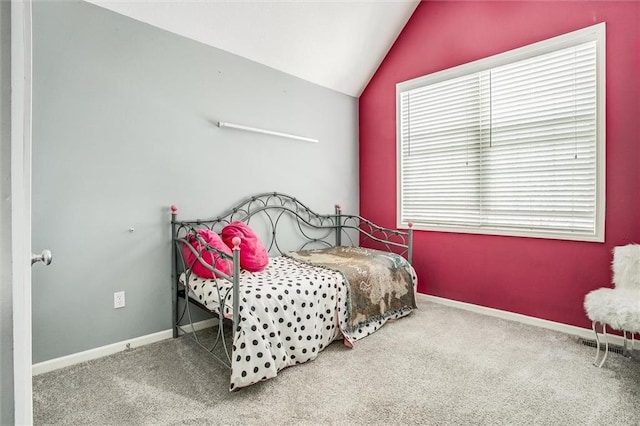 bedroom with baseboards, carpet, and vaulted ceiling